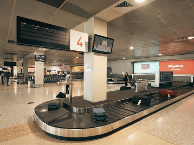 Melbourne Airport Terminal 1 arrivals hall — chauffeur meeting point at baggage carousel