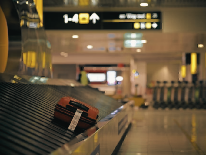 Melbourne Airport Terminal 4 arrivals hall — chauffeur meeting point at baggage carousel
